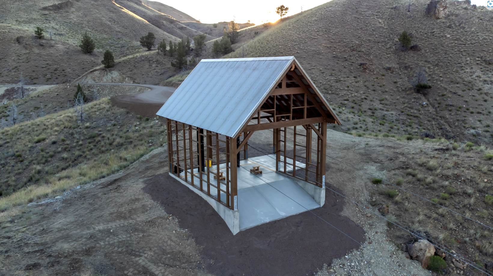 A steel aerial structure rising over open terrain